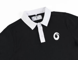 A black and white polo shirt with a logo on the chest.