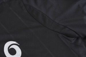 A close up of the side of a black shirt