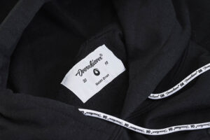 A close up of the label on a black hoodie