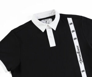 A black and white polo shirt with the word " excellence ".