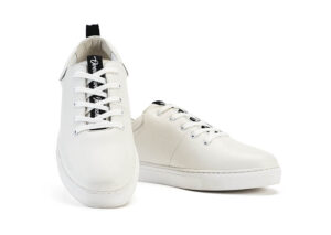 A pair of white sneakers with black laces.