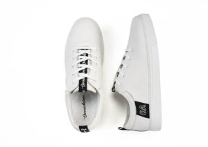 A pair of white shoes with black laces.