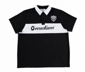 A black and white polo shirt with an overachiever logo on the front.